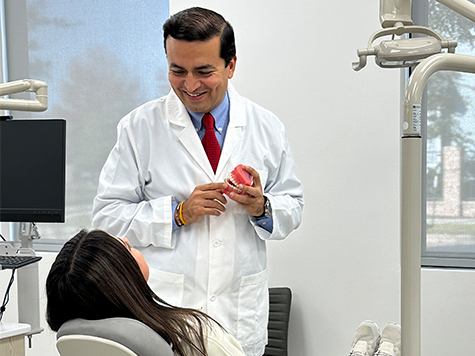 Photo of Dr. Bhagia of Space City Orthodontics with a patient at the Bridgeland location.