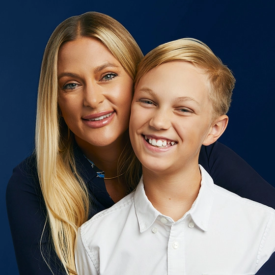 Mom and son smiling after orthodontic treatment together | Space City Orthodontics Houston, TX