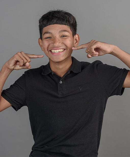 young orthodontic patient wearing black shirt smiling